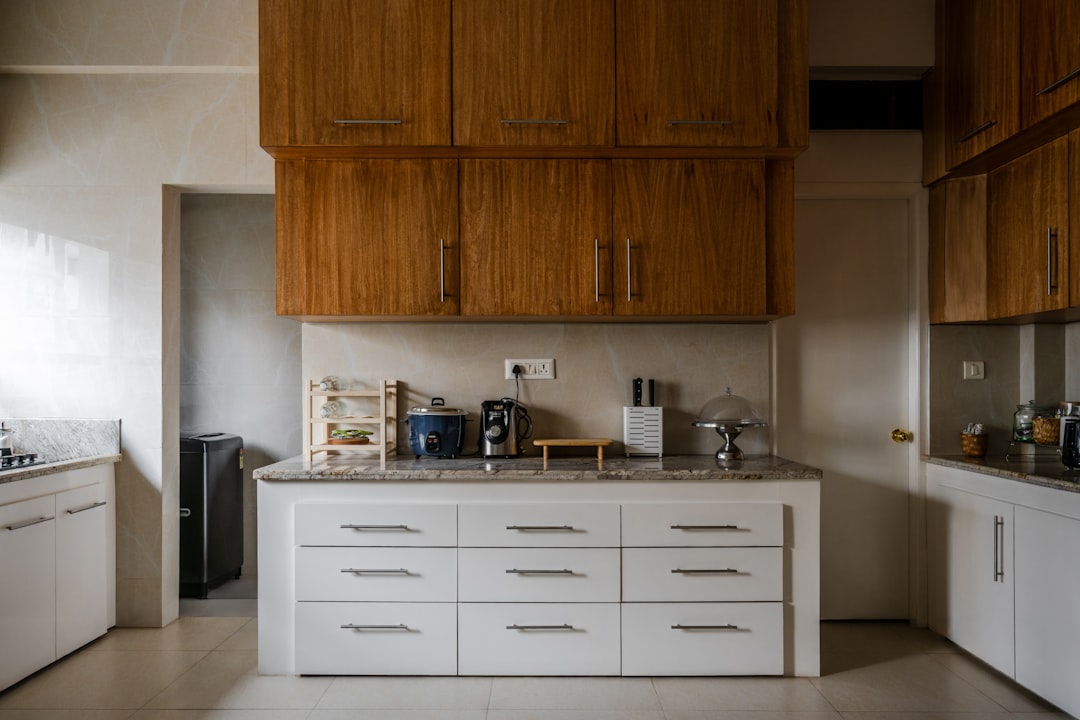 A neatly organized kitchen cabinet showcasing various storage solutions, including labeled containers and arranged dishes.