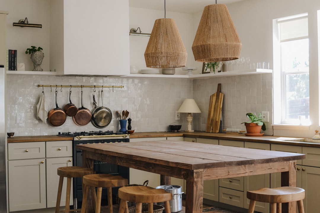 A bright and tidy kitchen with organized shelves, clean countertops, and cooking tools neatly arranged.